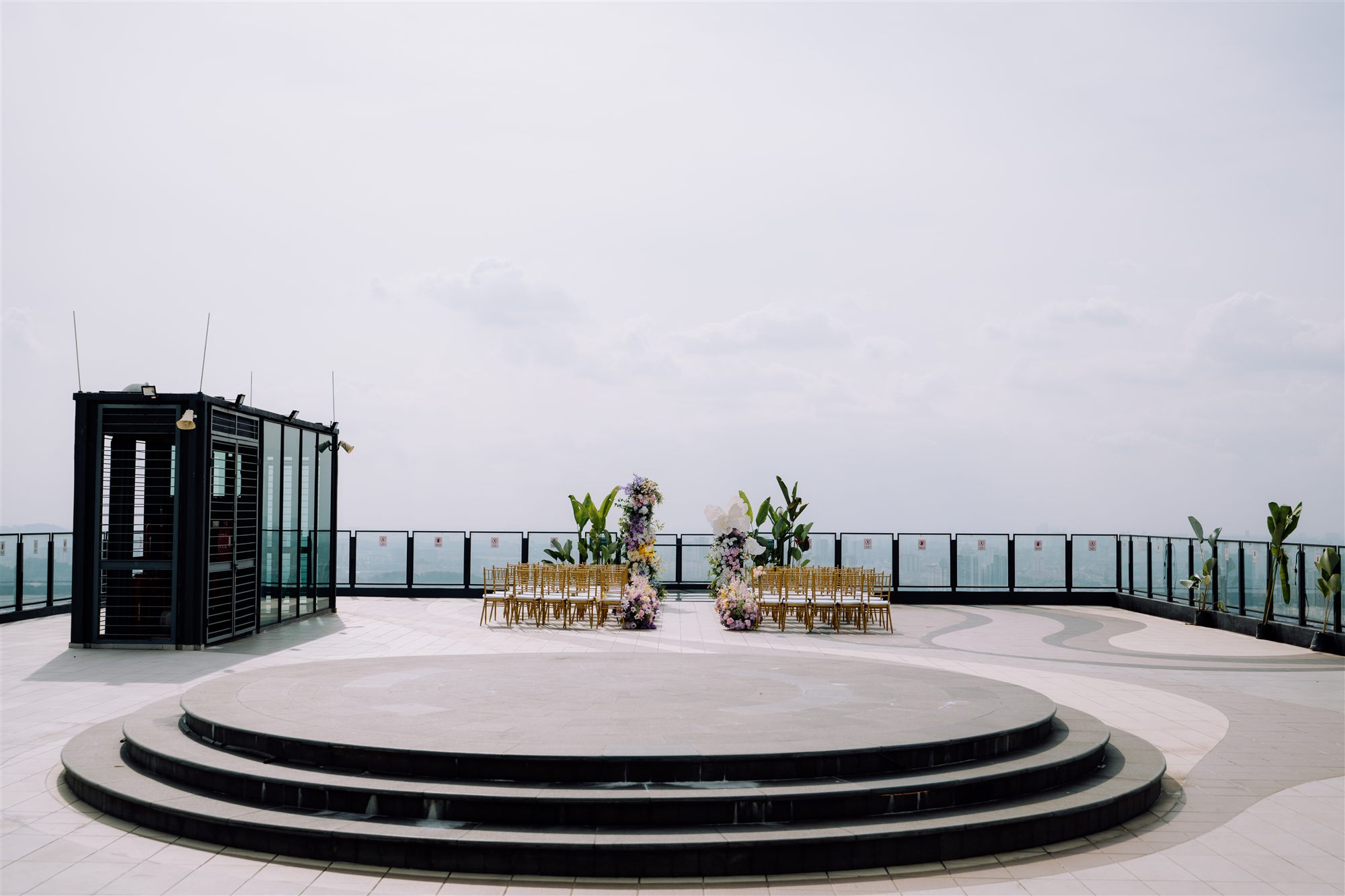Sky Deck ceremony setup with floral arch and guest chairs