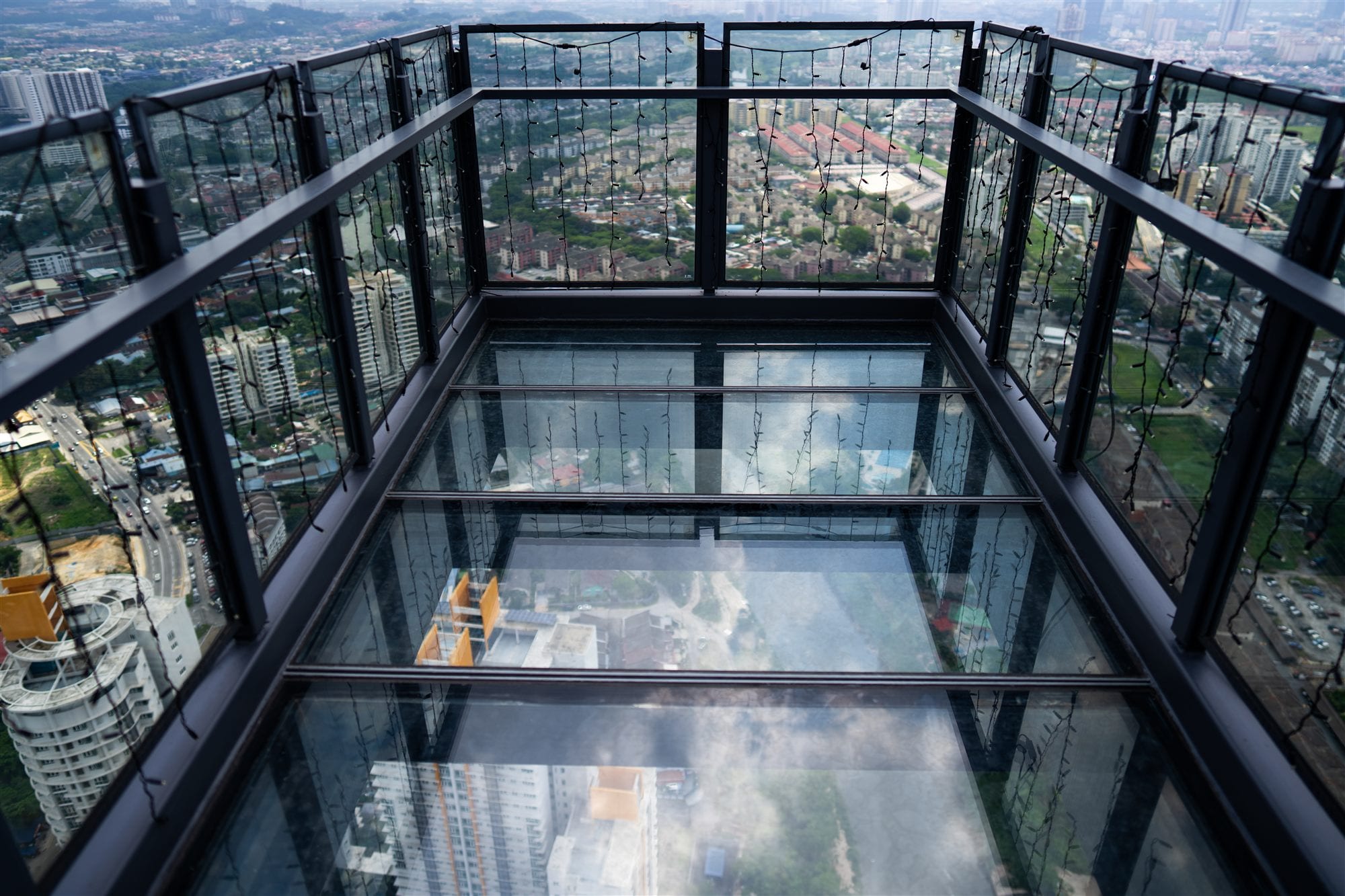 Glass floor skywalk at 63rd floor looking straight down over KL