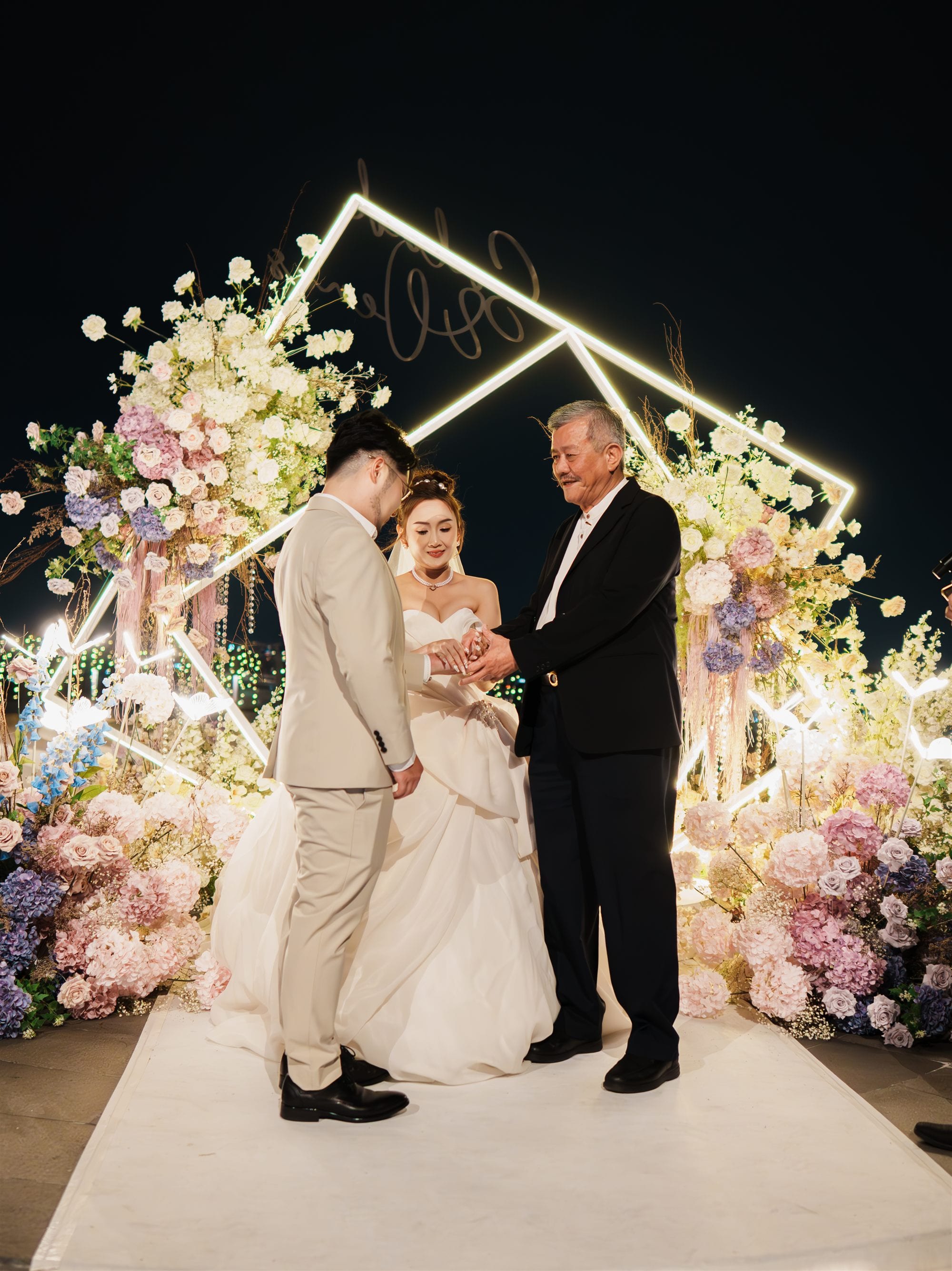Wedding ceremony at night with neon arch