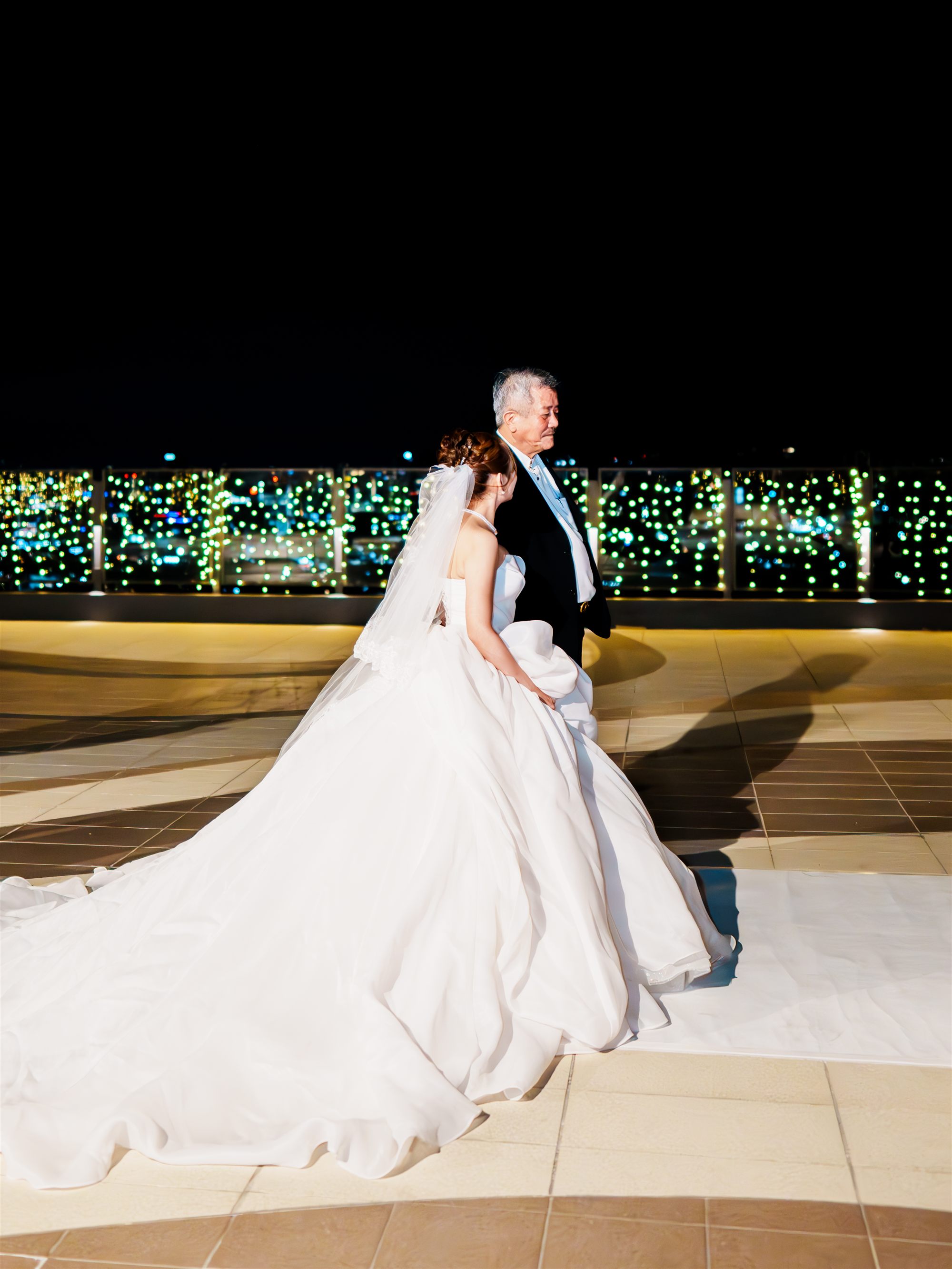 Wedding couple portrait at night with city lights