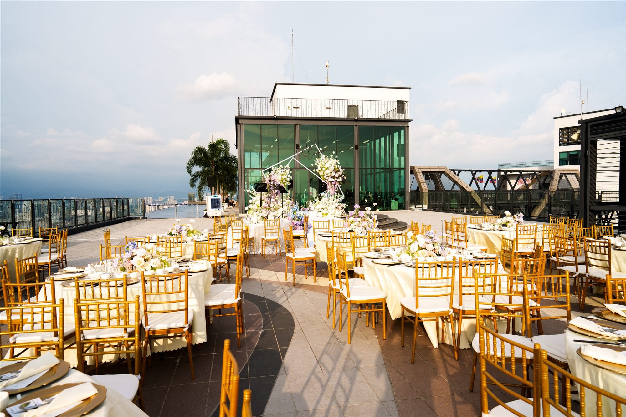 Wide shot of a wedding banquet ballroom with round tables set for dinner