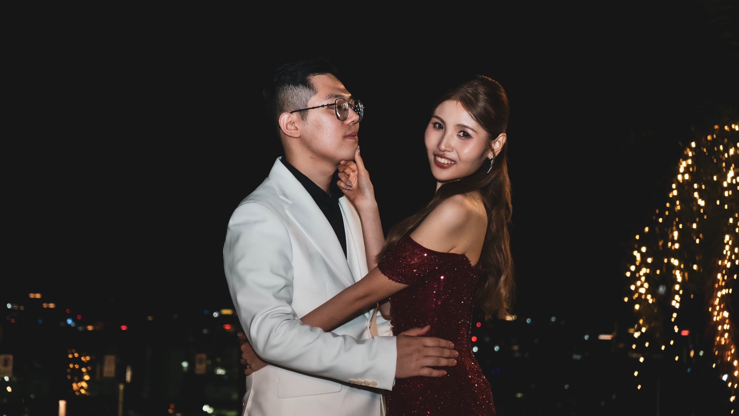 Couple portrait at night wedding celebration with KL city lights backdrop